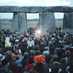 people gathering near gray concrete pillar during daytime